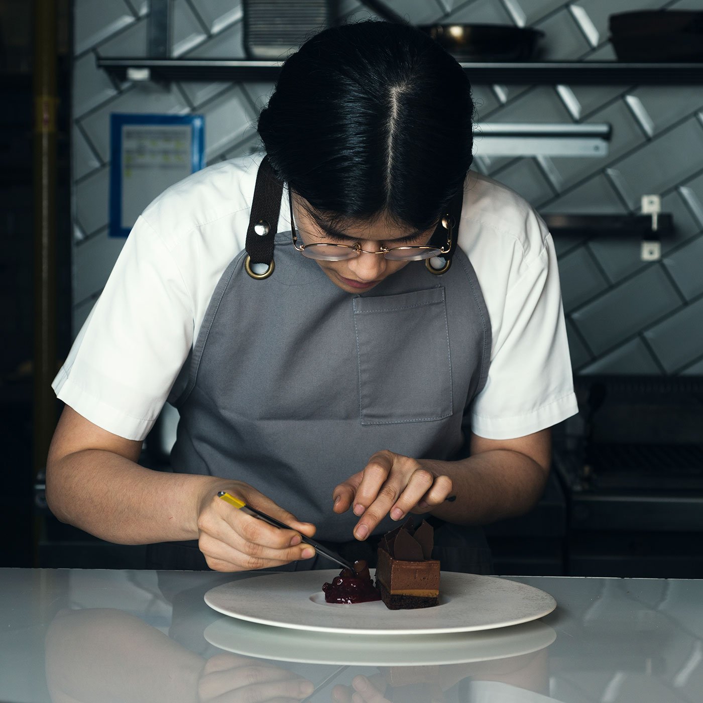 Alejandra Gul from Andes desert chef adding final touches to a dish